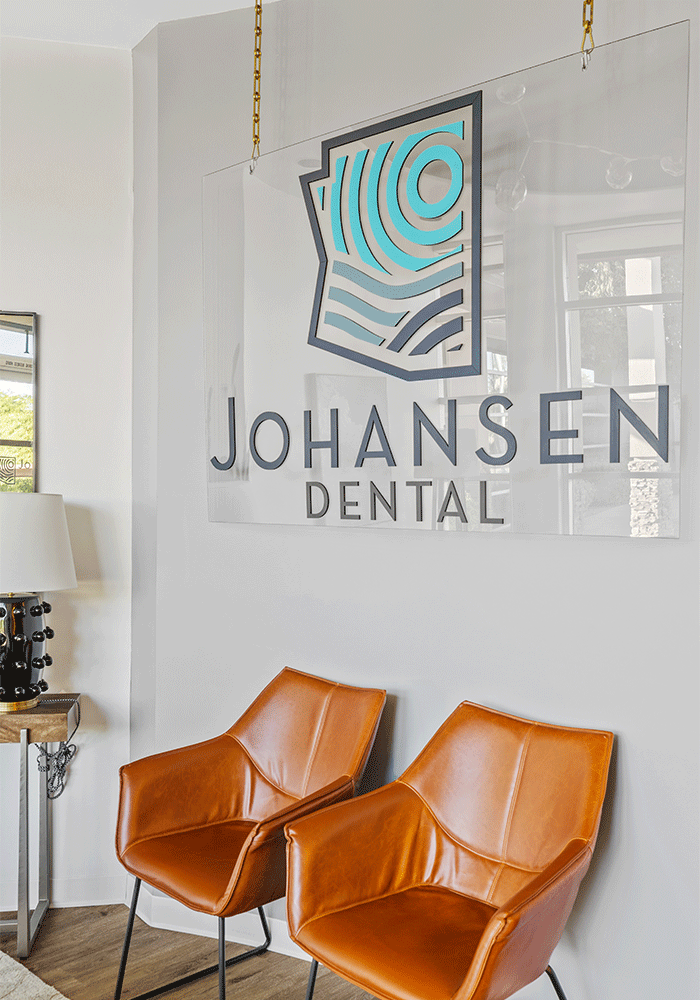Hanging glass sign in front lobby that reads "Johansen Dental".